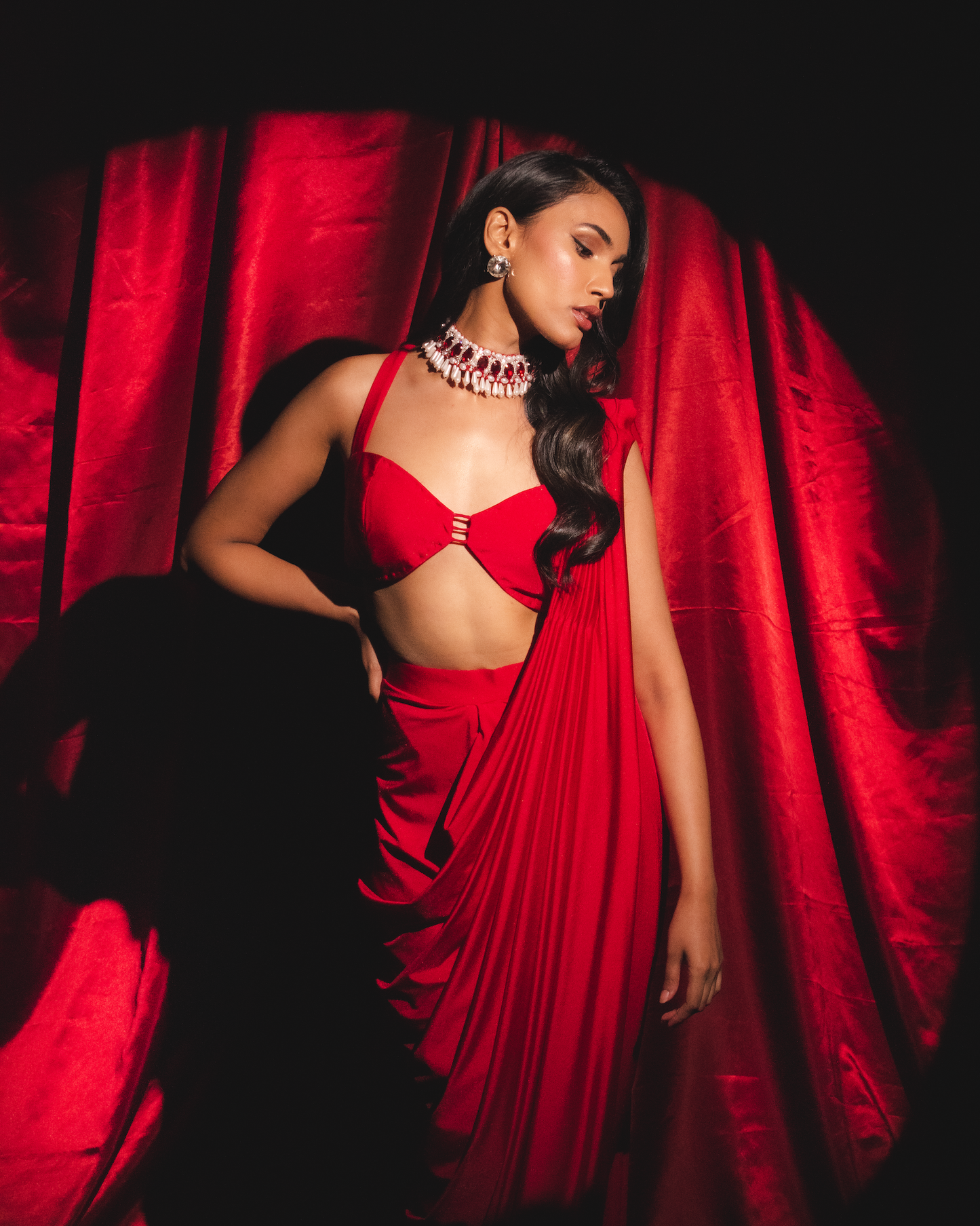 Roshni chopra X Anshika tak (Captivating Crimson Draped Saree with Alluring Blouse: A Dance of Elegance and Seduction)