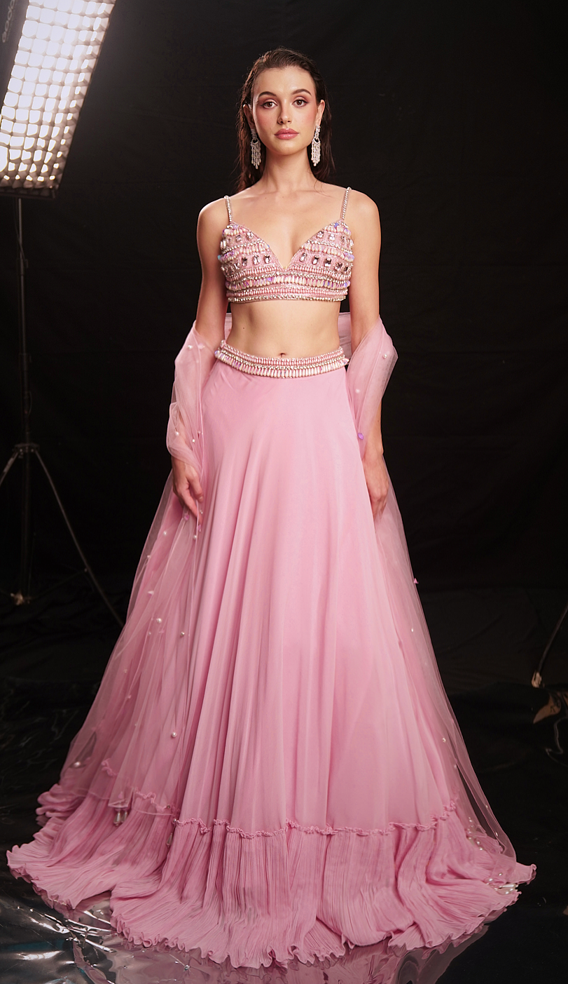Fresh pink mirror-embellished lehenga with a flowing ruffle-edged skirt and beaded blouse