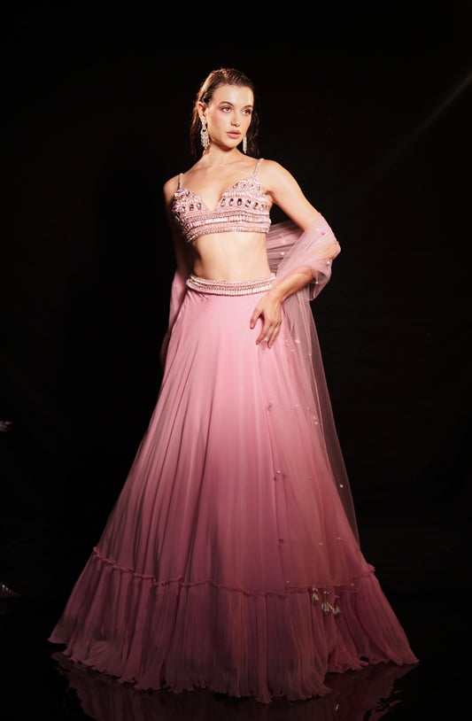 Fresh pink mirror-embellished lehenga with a flowing ruffle-edged skirt and beaded blouse