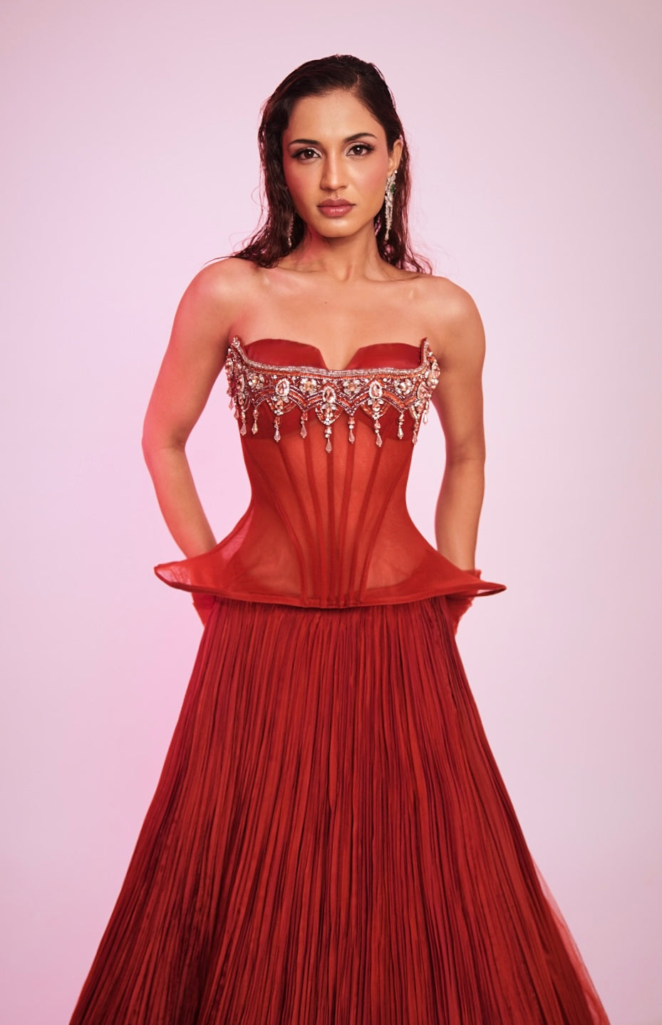 Rusty red strapless corset Lehenga with embellished bodice and pleated skirt