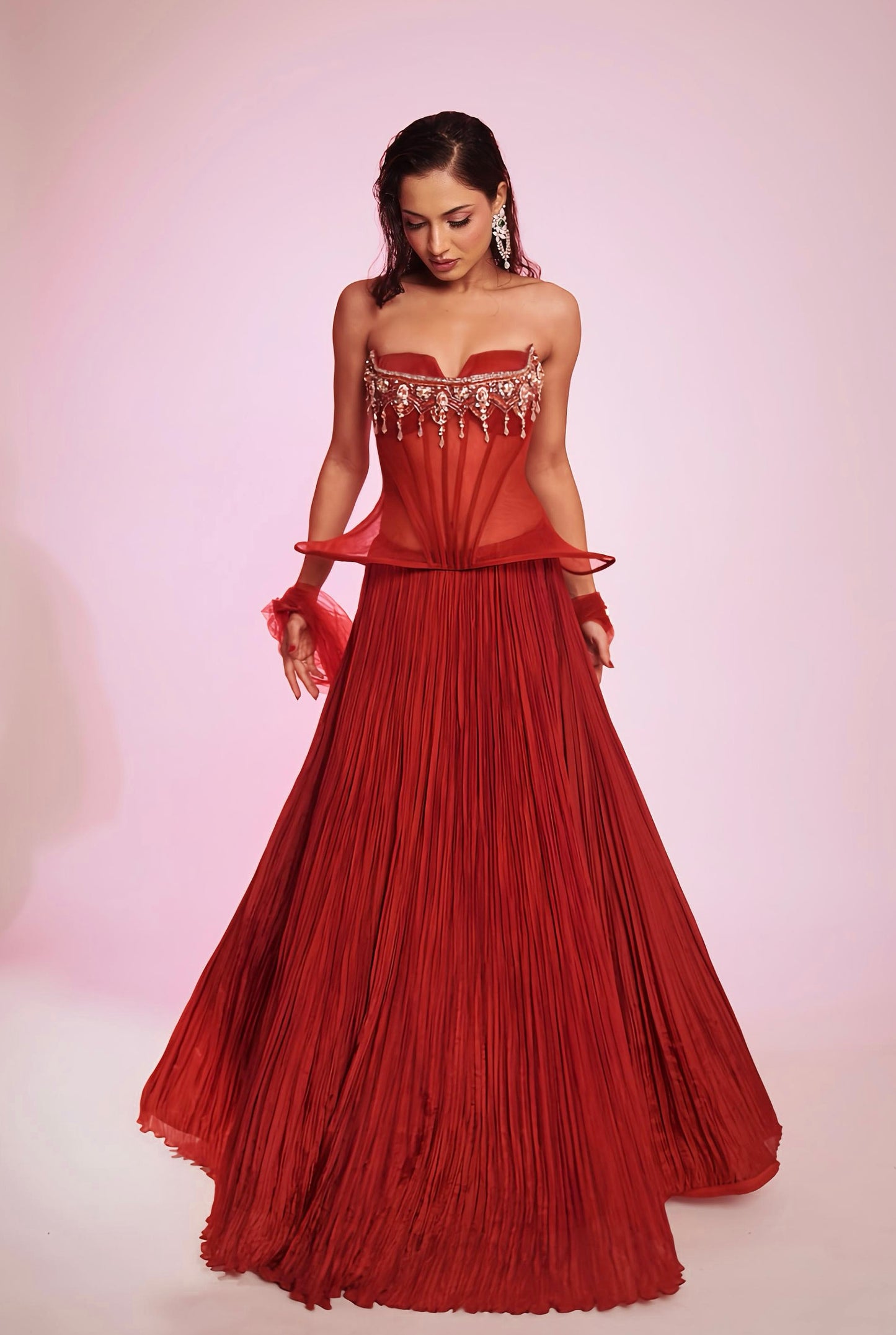 Rusty red strapless corset Lehenga with embellished bodice and pleated skirt