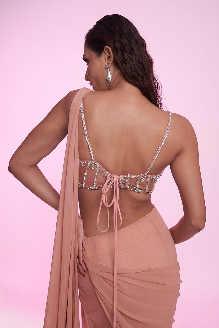 Blush peach draped saree gown with an embellished corset blouse.