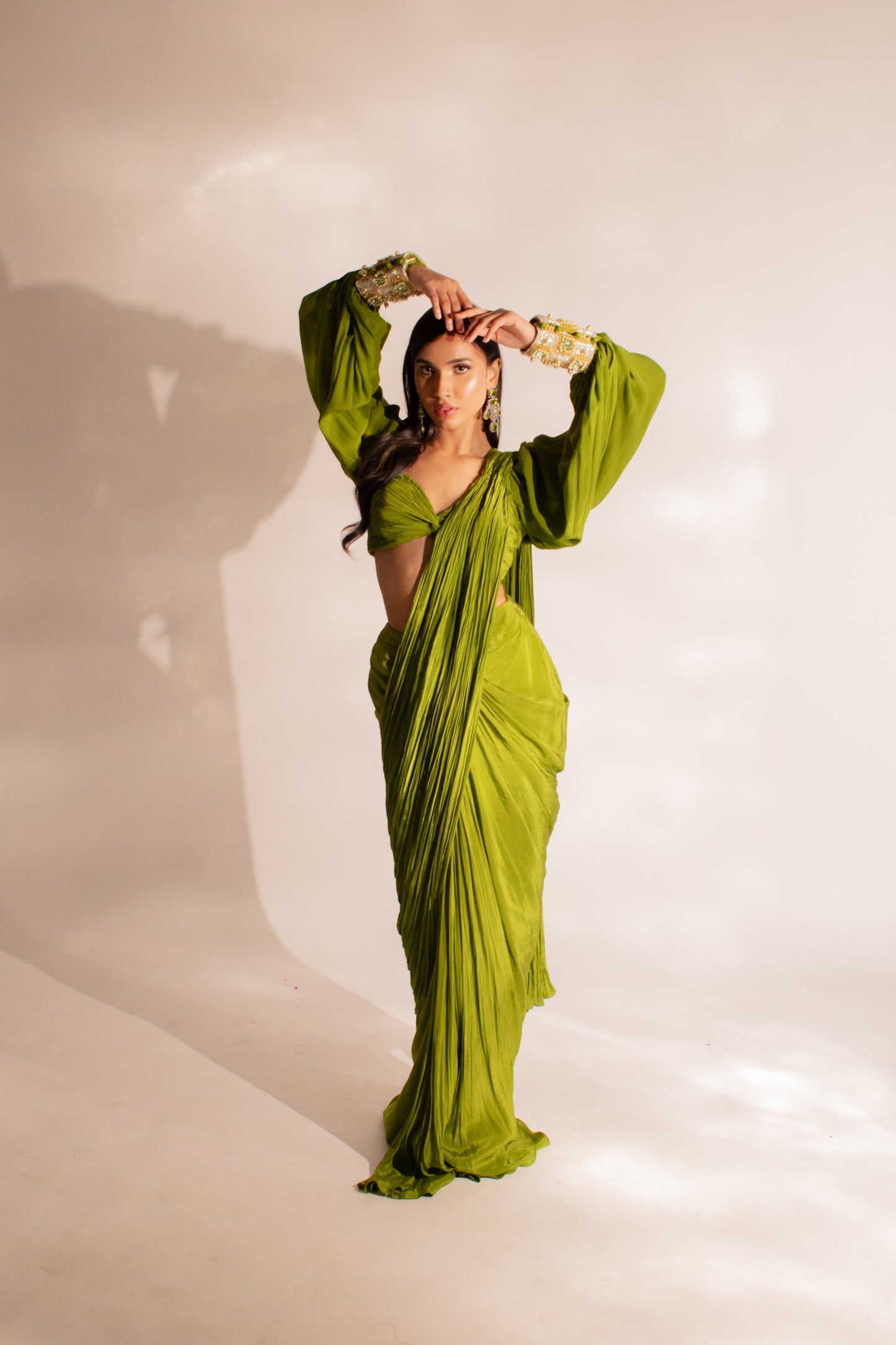Sanjana Batra X Anshika Tak Label ( Ruched Allure: Modern Olive Green Draped Saree with Puff and Cuff Sleeves )