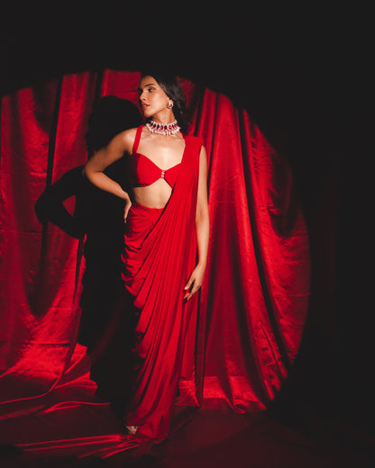 Roshni chopra X Anshika tak (Captivating Crimson Draped Saree with Alluring Blouse: A Dance of Elegance and Seduction)