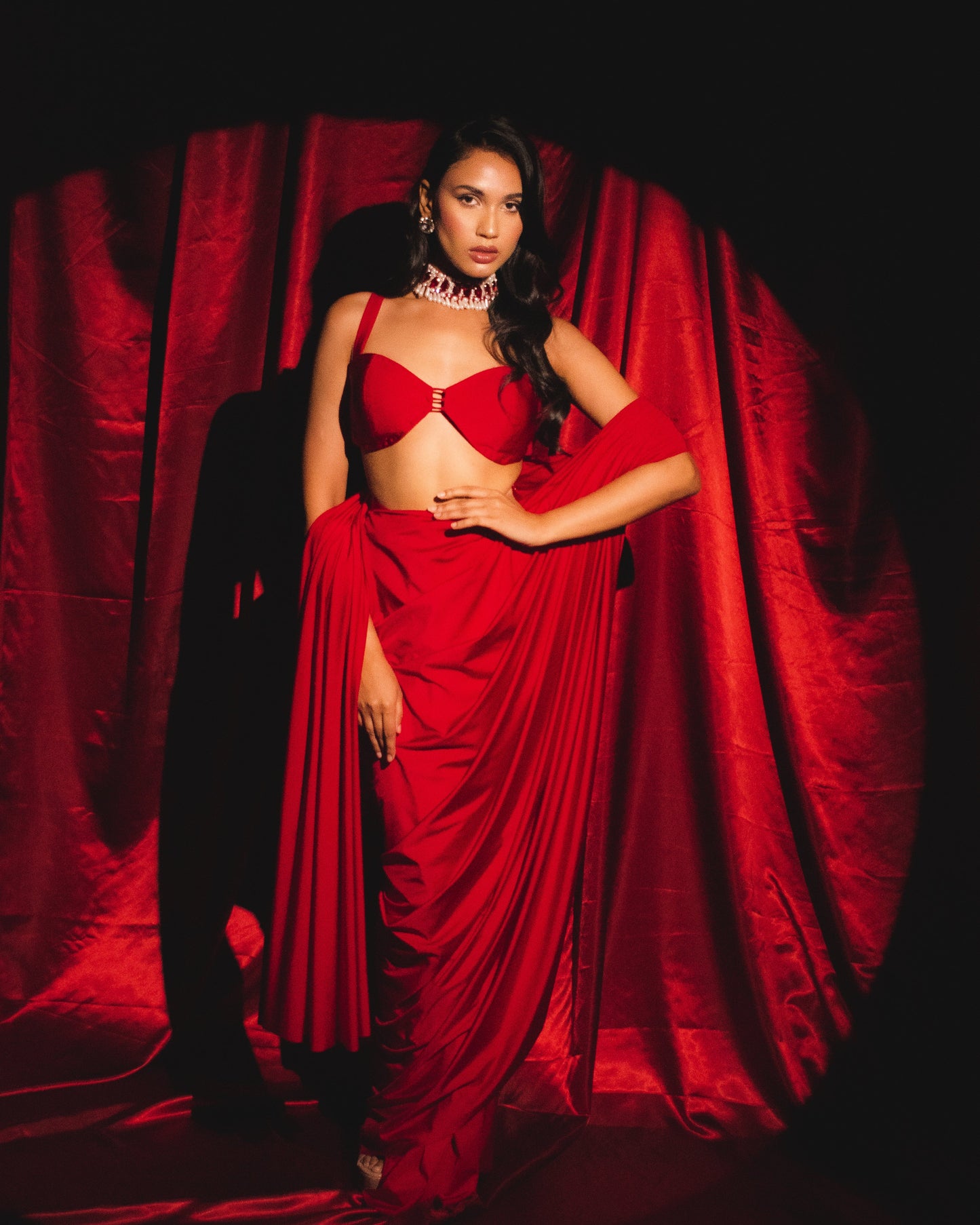 Roshni chopra X Anshika tak (Captivating Crimson Draped Saree with Alluring Blouse: A Dance of Elegance and Seduction)