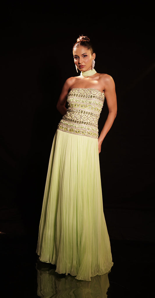 Pastel green strapless gown with embellished bodice and flowing pleated skirt