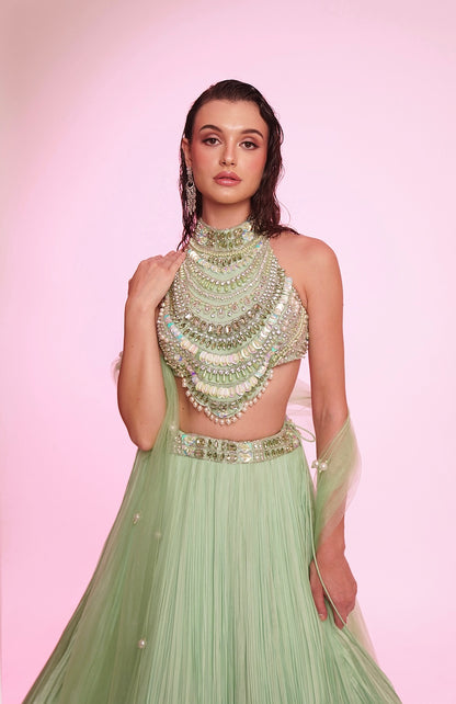 Mint green embellished halter-neck lehenga set with a statement jeweled bodice.