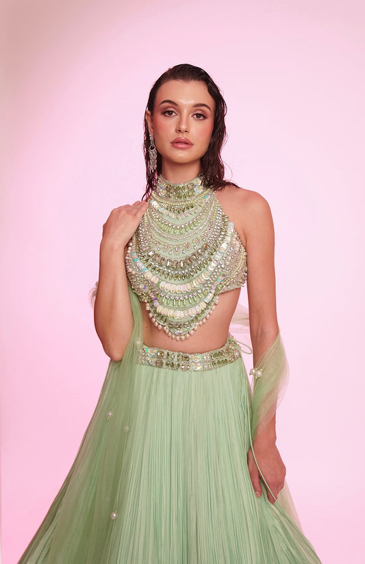 Mint green embellished halter-neck lehenga set with a statement jeweled bodice.