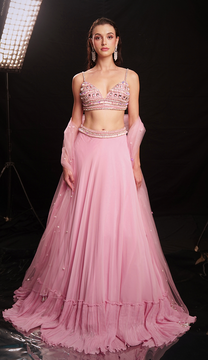 Fresh pink mirror-embellished lehenga with a flowing ruffle-edged skirt and beaded blouse