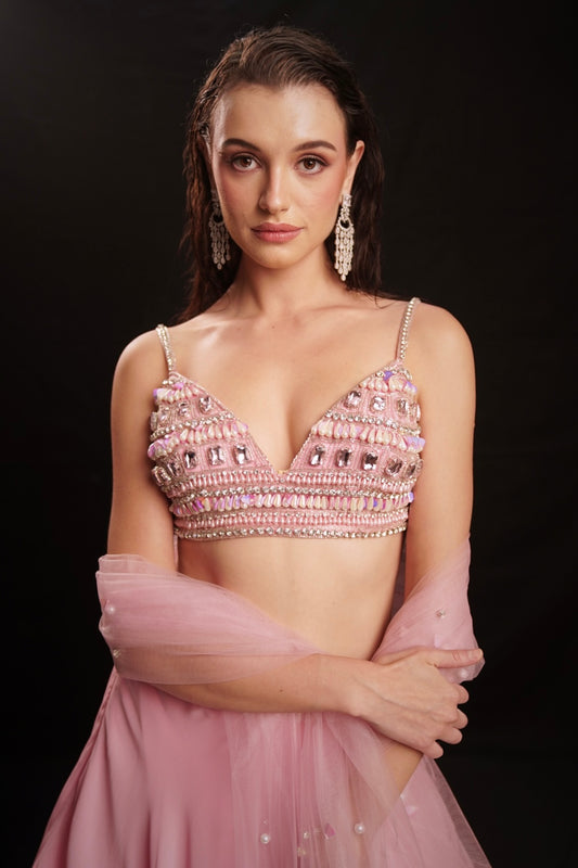 Fresh pink mirror-embellished lehenga with a flowing ruffle-edged skirt and beaded blouse