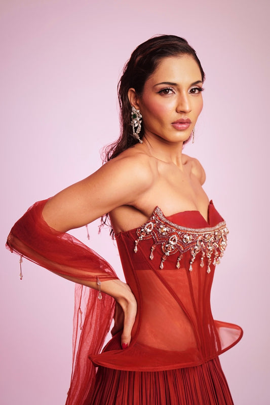 Rusty red strapless corset Lehenga with embellished bodice and pleated skirt