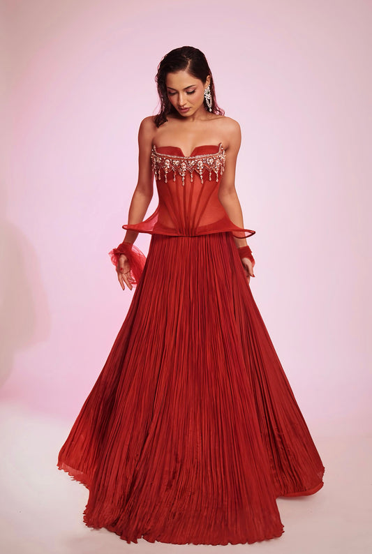 Rusty red strapless corset Lehenga with embellished bodice and pleated skirt