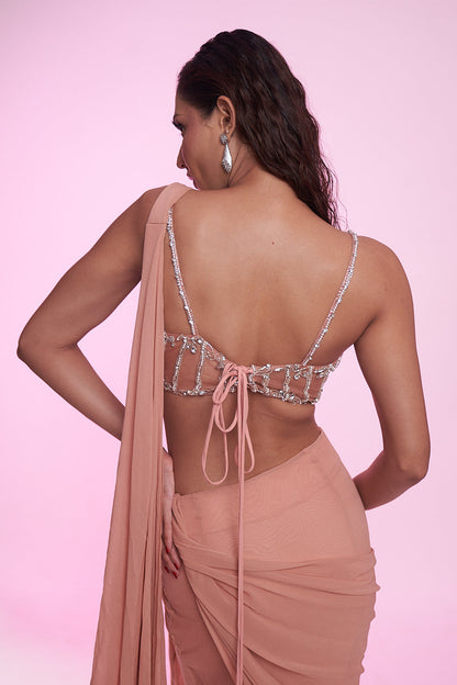 Blush peach draped saree gown with an embellished corset blouse.